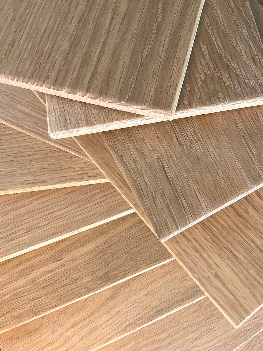TALAYA Solid Ground Honey Oak tiles fanned and layered in two orientations with warm natural sidelight creating a glowing gradient effect