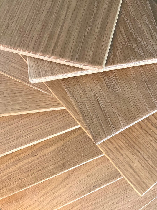 TALAYA Solid Ground Honey Oak tiles fanned and layered in two orientations with warm natural sidelight creating a glowing gradient effect