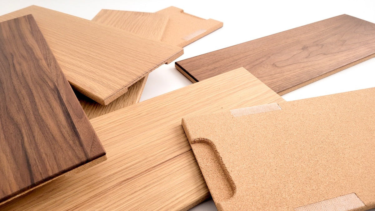 TALAYA Solid Ground tiles in Honey Oak and Walnut Mocha finishes, artfully arranged face-up and cork-side up on white background