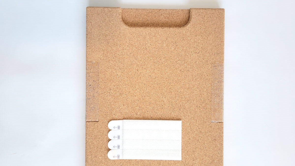 TALAYA Solid Ground tile, detail view of cork backing and handle end with included adhesive picture hangers

