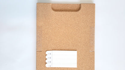 TALAYA Solid Ground tile, detail view of cork backing and handle end with included adhesive picture hangers

