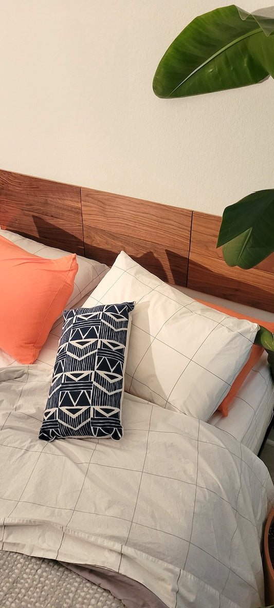 TALAYA Solid Ground tile set in Walnut Mocha finish installed on earthy minimalist bedroom wall, high angled view